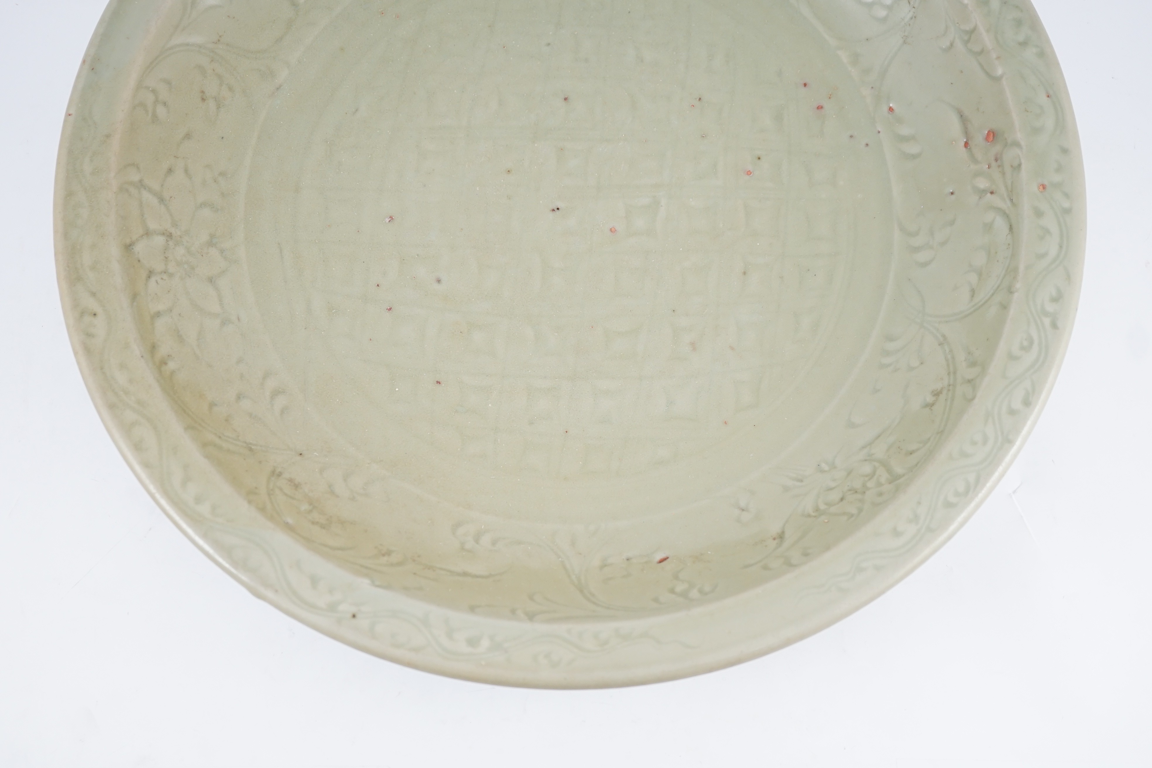 A Chinese Ming Longquan celadon ‘diaper and floral’ charger, 15th century, 45cm diameter, wear to glaze
